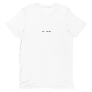 *not a tourist Short-Sleeve Unisex T-Shirt (center)