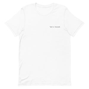 *not a tourist Short-Sleeve Unisex T-Shirt (left)