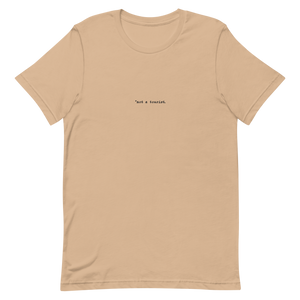 *not a tourist Short-Sleeve Unisex T-Shirt (center)